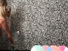 Sexy slim blonde teen putting on a sensual striptease show