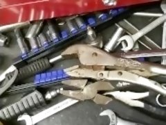 Mechanic plays with his tools